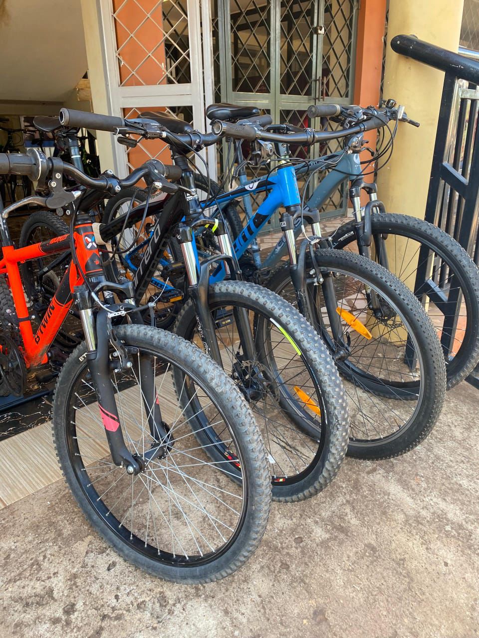 Bikes for sale lined up under a covered walkway